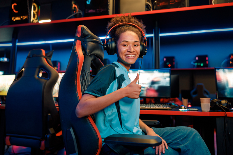 girl giving thumbs up while competing in esports